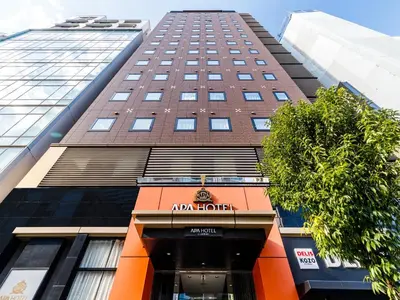 a tall building with an amazon hotel sign on it at APA Hotel Mita Ekimae in Tokyo