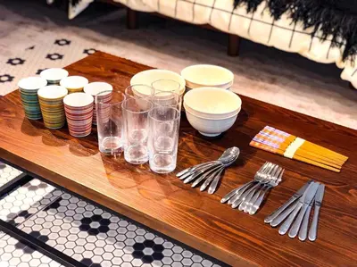 a table with plates and glasses and forks and spoons at Yoyogi Apartment 2-301 by Tranova in Tokyo