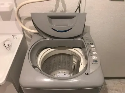 a close up of a silver toilet in a bathroom at Yoyogi Apartment 2-301 by Tranova in Tokyo