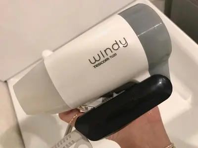 a person holding a juicer in their hand at Yoyogi Apartment 2-301 by Tranova in Tokyo
