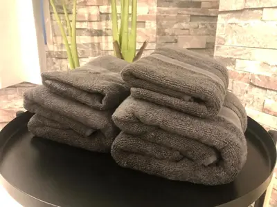 a pile of towels sitting on top of a table at Yoyogi Apartment 2-301 by Tranova in Tokyo