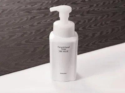 a white bottle of liquid soap sitting on a counter at APA Hotel Shibuya Dogenzakaue in Tokyo