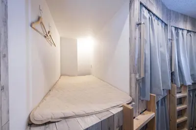 a small room with a mattress on the floor and a closet at bnb+ Kanda Terrace Ogawamachi in Tokyo