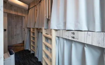 a room with a curtain and a window with a timestamp at bnb+ Kanda Terrace Ogawamachi in Tokyo