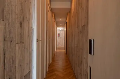 a hallway with wood paneling and a long corridor at bnb+ Kanda Terrace Ogawamachi in Tokyo
