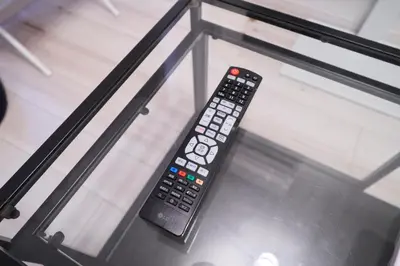 a remote control sitting on top of a bed at FINOA Residential Suite IKEBUKURO - 5BR Large Vacation Home in Tokyo