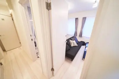 a view of a living room with a couch from a hallway at FINOA Residential Suite IKEBUKURO - 5BR Large Vacation Home in Tokyo