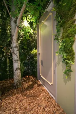 a door leading into a garden with a tree at THE WARDROBE Hotel Shimokitazawa in Tokyo