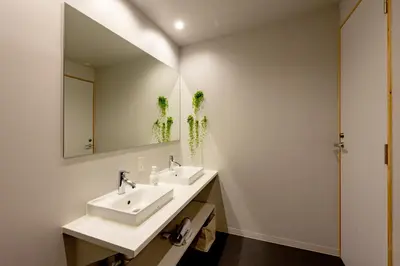 a bathroom with two sinks and a mirror at plat hostel keikyu minowa forest in Tokyo