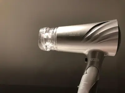 a close up of a hair dryer with a brush at plat hostel keikyu minowa forest in Tokyo