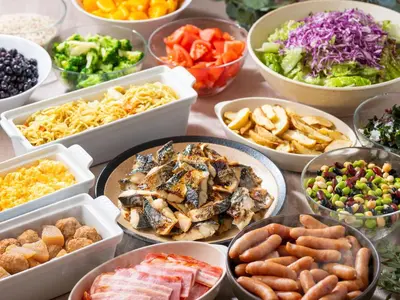 a table topped with bowls of different types of food at APA Hotel PRIDE Akasaka Kokkaigijidomae in Tokyo