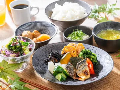 a table with plates of food and bowls of rice at APA Hotel PRIDE Akasaka Kokkaigijidomae in Tokyo