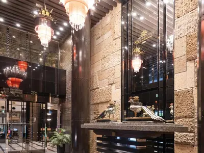 a lobby of a building with chandeliers at APA Hotel PRIDE Akasaka Kokkaigijidomae in Tokyo