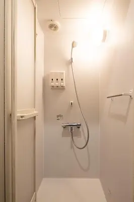 a shower in a bathroom with a glass door at Hotel Owl Tokyo Shinbashi in Tokyo