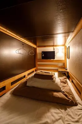 a bedroom with a large bed in a room at Hotel Owl Tokyo Shinbashi in Tokyo
