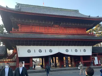 two men are standing in front of a building at Hotel Owl Tokyo Shinbashi in Tokyo