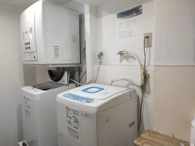 a laundry room with a washer and a washing machine at Matsui Building in Tokyo