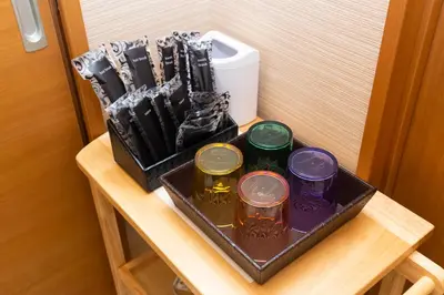 a tray with four different colored jars on a table at Matsui Building in Tokyo