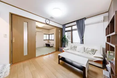 a living room with a white couch and a mirror at \u6771\u4eac\u82b3\u534e\u9a7f\u7ad9 in Tokyo