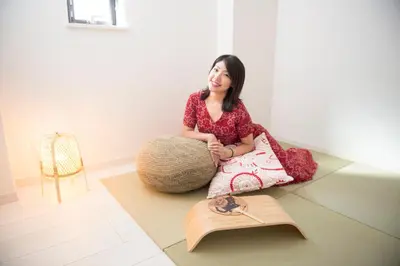 a woman sitting on the floor in a room at Cozy Vibes Apt Hotel in Tokyo