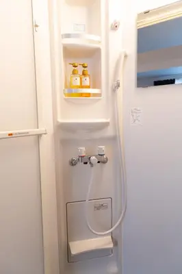 an open refrigerator with bottles of honey in it at Cozy Vibes Apt Hotel in Tokyo