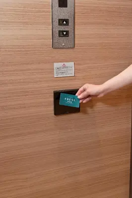 a person opening a door with their hand on it at Sotetsu Fresa Inn Tokyo-Toyocho in Tokyo