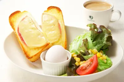 a plate of food with a sandwich and salad and a cup of coffee at Sotetsu Fresa Inn Tokyo-Toyocho in Tokyo