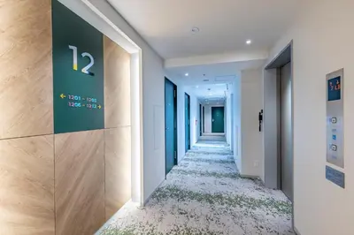 a corridor in a building with a sign on the wall at Tokyu Stay Shibuya Shin-Minamiguchi in Tokyo