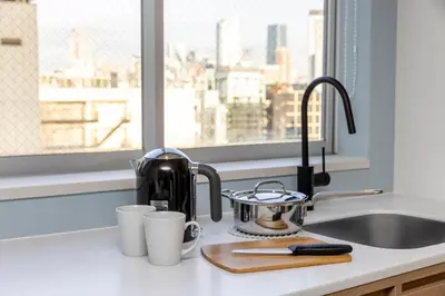 a kitchen counter with a coffee pot and cups at Tokyu Stay Shibuya Shin-Minamiguchi in Tokyo