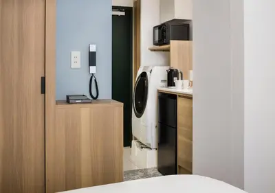 a kitchen with a washer and dryer in a room at Tokyu Stay Shibuya Shin-Minamiguchi in Tokyo