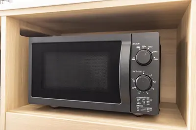 a microwave oven sitting inside of a shelf at Tokyu Stay Shibuya Shin-Minamiguchi in Tokyo