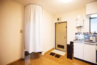 a bathroom with a shower and a white curtain at Murata Corpo 305 in Tokyo