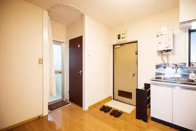 a room with a kitchen with shoes on the floor at Murata Corpo 305 in Tokyo