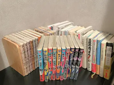 a row of books sitting on a table at Book Tea Bed SHINJUKU-GYOEN in Tokyo