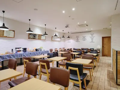 a dining room filled with tables and chairs at hotel MONday Tokyo Nishikasai in Tokyo