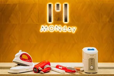 a sign that reads monday with a hair dryer and a toaster at hotel MONday Tokyo Nishikasai in Tokyo
