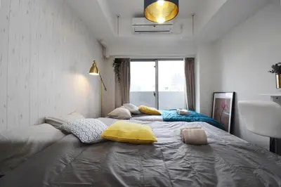 a large bed in a room with a window at Square Shibuya 909 in Tokyo