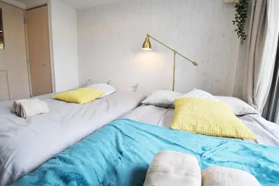 two beds sitting next to each other in a room at Square Shibuya 909 in Tokyo