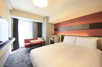a hotel room with a white bed and a chair at Keisei Richmond Hotel Tokyo Monzennakacho in Tokyo