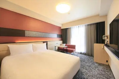 a hotel room with a white bed and a television at Keisei Richmond Hotel Tokyo Monzennakacho in Tokyo
