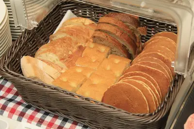 a basket full of bread on a table at Keisei Richmond Hotel Tokyo Monzennakacho in Tokyo