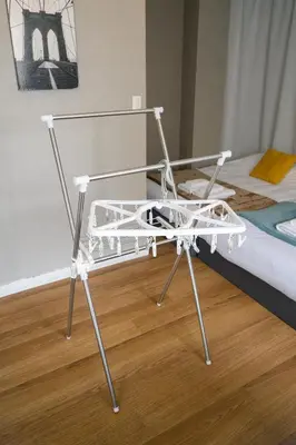 a white chair sitting next to a bed at Maison Nagasaki 201 in Tokyo