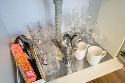 a shelf with glasses and cups on it at Maison Nagasaki 201 in Tokyo
