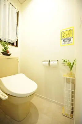 a bathroom with a toilet and plants in it at Asakusa Kei House in Tokyo
