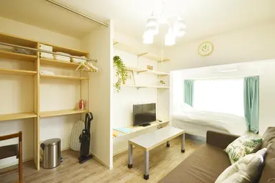 a living room with a couch and a bed at Roppongi WoodsHouse501 in Tokyo