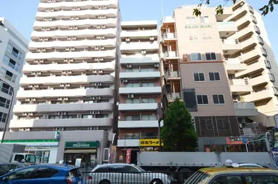 a city street with cars parked in front of tall buildings at Roppongi WoodsHouse501 in Tokyo