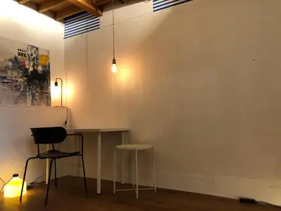 a room with two stools and a white wall at Shimokitazawa Private House in Tokyo