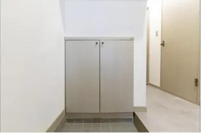 a bathroom with white walls and a white cabinet at Shimokitazawa Private House in Tokyo