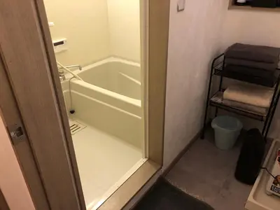 a bathroom with a bath tub and a towel rack at Shimokitazawa Private House in Tokyo