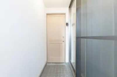 a hallway with a door and a tile floor at Shimokitazawa Private House in Tokyo